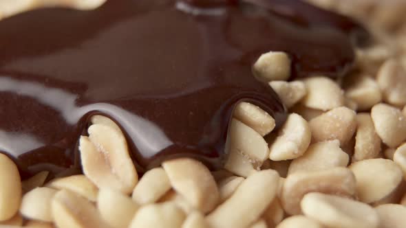 Pouring Melted Chocolate Onto Peanuts