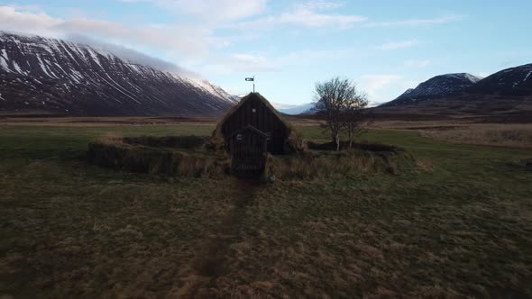 Aerial view pull back of young girl walking to chucrh in Iceland