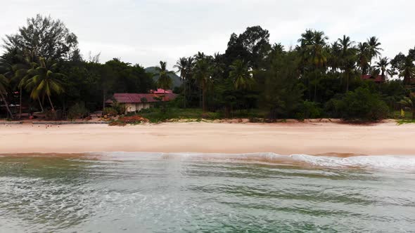 Aerial dolly shot of a Thai beach in Khanom, Thailand.