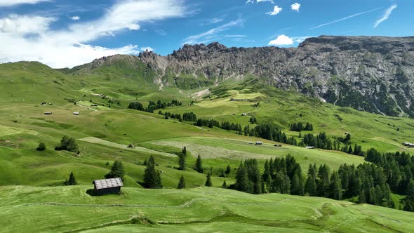 Wooden cottages under the mountains on a sunny summer day