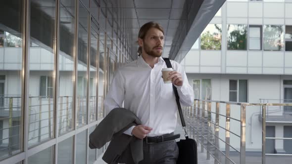 Young Caucasian Businessman Drinking Coffee on Morning Commute to Work
