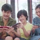 ,asian parent and son sit relax playing game console or smart together laugh joyful - VideoHive Item for Sale
