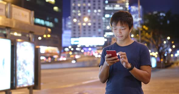 Man Use of Mobile Phone in The Street at Night