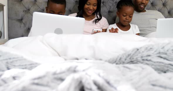 Family using electronic devices in bedroom 4k