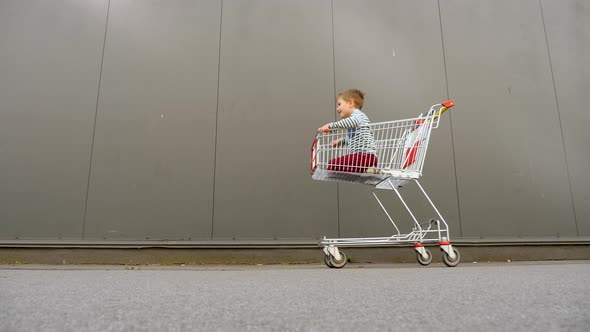 Shopping Concept. Black Friday Background. Father with Son Hurry Up for Discounts. Consumption