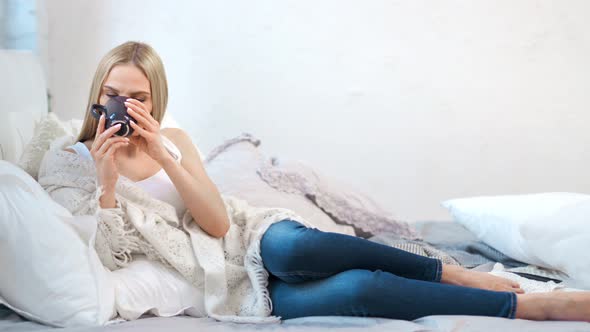 Lonely Barefoot Woman Wrapped in Plaid Drinking Hot Beverage and Thinking Full Shot