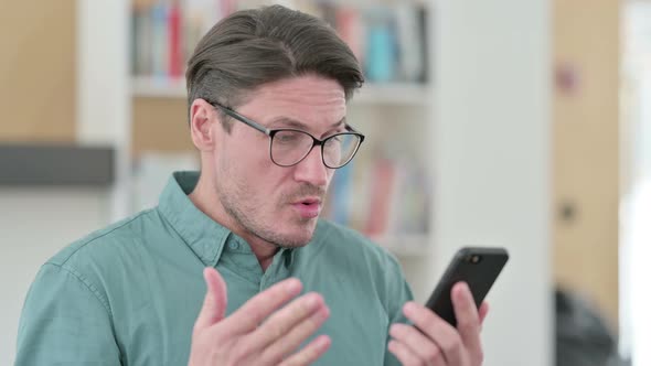 Middle Aged Man Having Loss on Smartphone