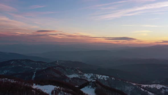 Aerial view at the mountain on a sunset of the winter day