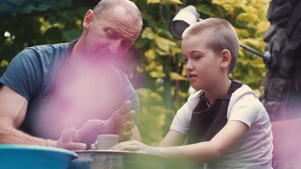 Grandfather with a Grandson Make Pitchers in Pottery