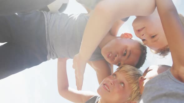 Video of happy diverse boys holding arms and talking