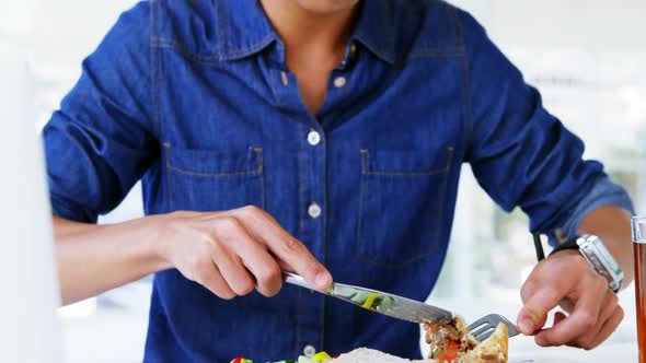 man eating lunch with drink wearing smartwatch