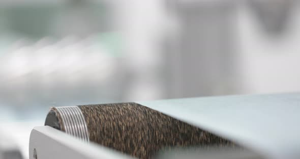 Fabric Running To Pleating Reel Of A Machine In Protective Mask Production Facility. panning left, r