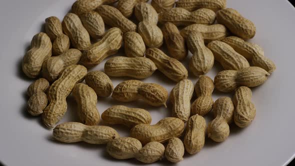 Cinematic, rotating shot of peanuts on a white surface - PEANUTS 007