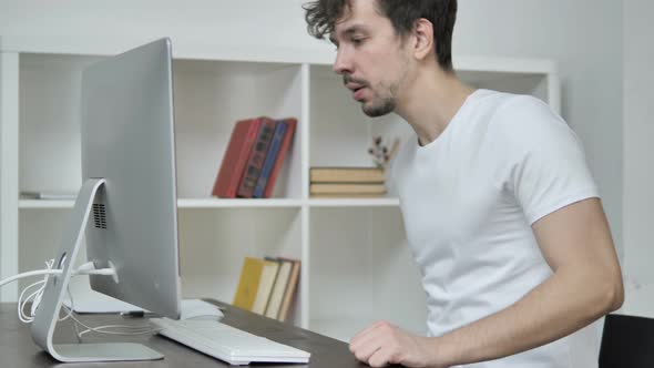 Young Creative Man Coming To Office and Working On Desktop