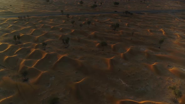 Aerial view above of dunes during scenic sunset, U.A.E.