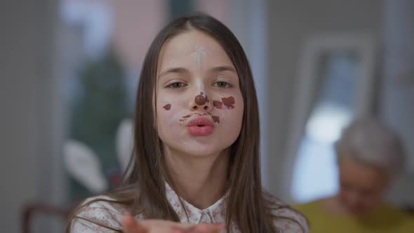 Front View Closeup Cheerful Teenage Caucasian Girl Gesturing Air Kiss Smiling Looking at Camera