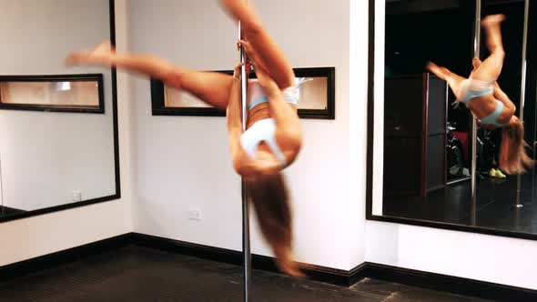 Pole dancer practicing pole dance