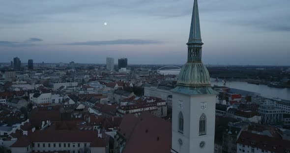 Aerial shot of St. Martin Church in Bratislava at twilight with moon in sky
