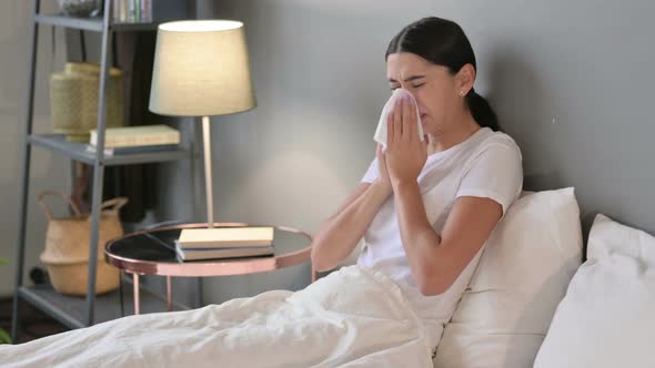 Allergic Young Latin Woman Sneezing in Bed 