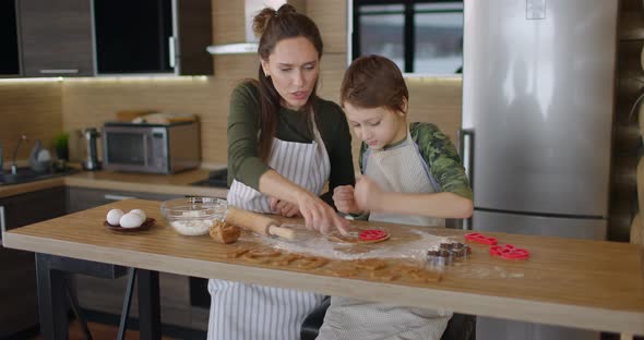 Young Family Mother and Son Making Homemade Cookies at Kitchen