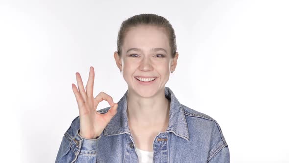 Portrait of Casual Young Woman Gesturing Okay Sign