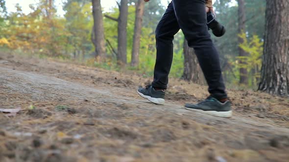 Man with camera hiking in the forest