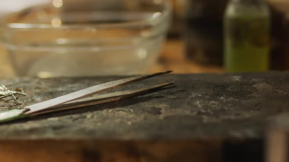 Close up of tweezers and jeweller tools lying on desk in workshop