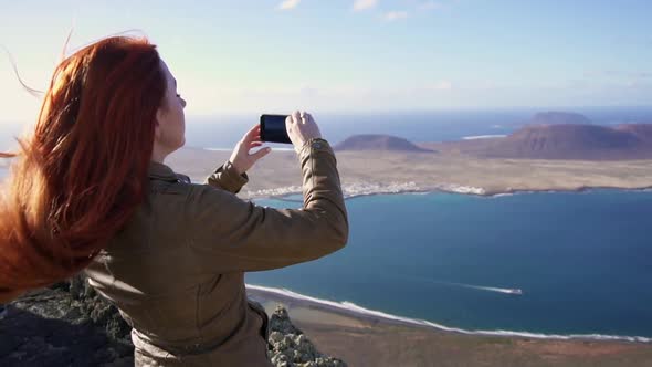 Happy Woman Tourist Shoots Video of Beautiful View of Islands Using Smartphone