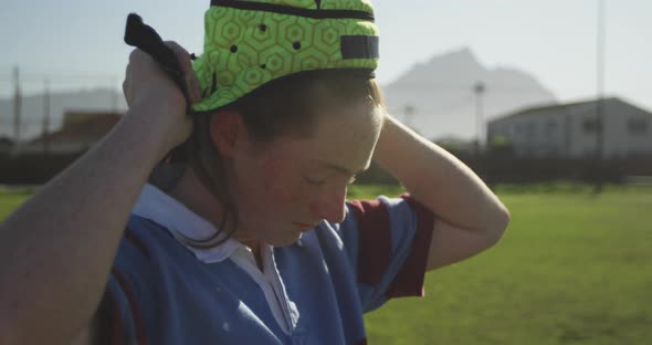 Young adult female rugby player on a rugby pitch