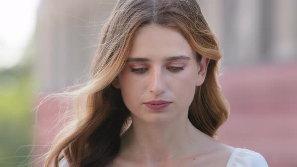 Headshot Portrait of Sad Young Woman