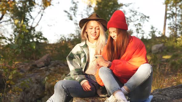 Two Best Friends Look at Photos They Took in Forest