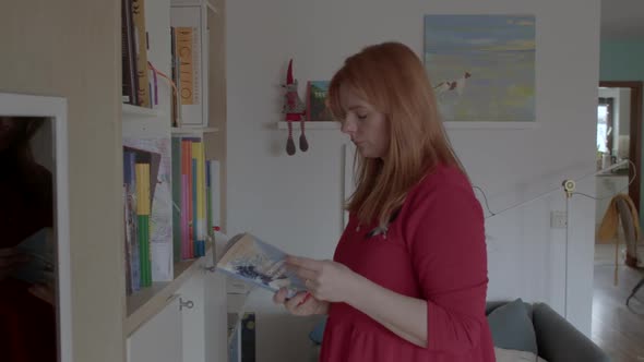 Woman with an Art Therapy Encyclopedia Book in Russian From Home Library