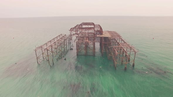 Burnt old fire damaged West Pier, Brighton, Sussex, England. Aerial drone view