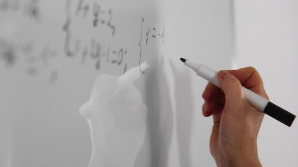 Female Student is Writing Math Equation on Whiteboard in the Cabinet