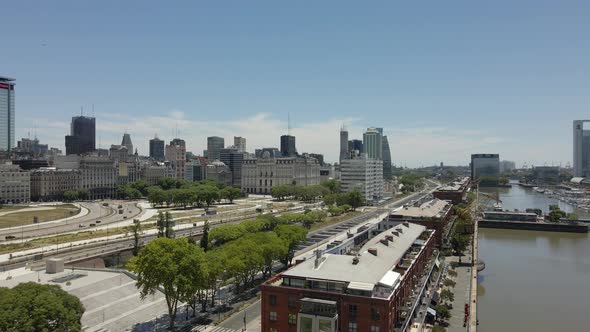 Waterfront Restaurants By The Riverbank In Puerto Madero With Buenos Aires Skyline In Background - d