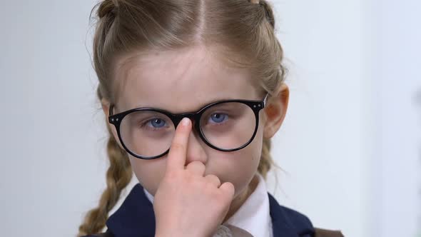 Smart Schoolgirl Adjusting Eyeglasses Closeup, Elementary School Pupil Education