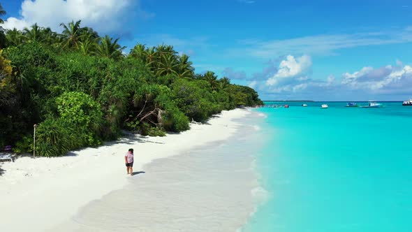 One woman happy and smiling on perfect coast beach vacation by blue lagoon and white sandy backgroun