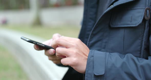 Man use of cellphone in the park