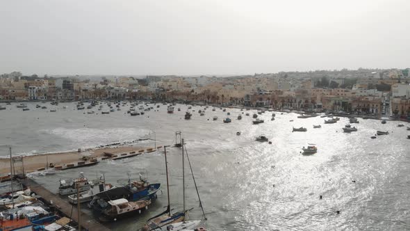 Aerial Wide View Of The Port in Marsaxlokk Malta With Village Background