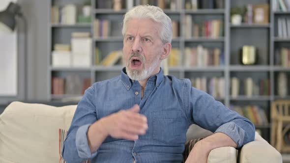 Sleepy Man Yawning on Sofa