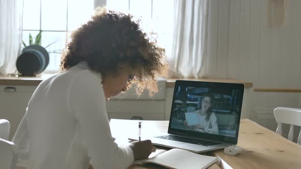 African Girl Attends Online Lesson Sitting Against Laptop