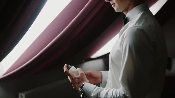 Close Up. Handsome Business Man or Groom Using Perfume. Slow Motion