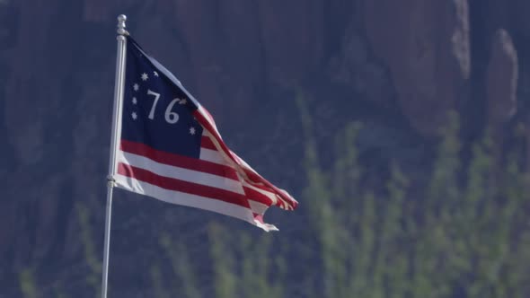 American 76 flag wide shot full speed against mountains