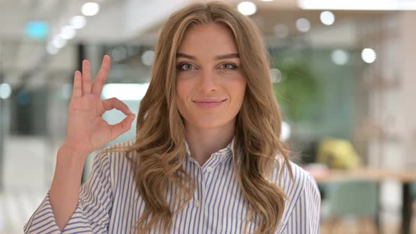 Portrait of Beautiful Businesswoman Showing OK Sign 