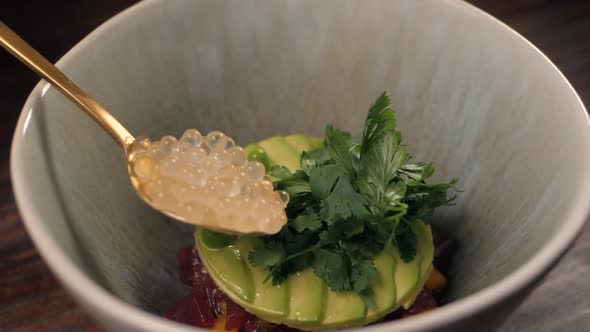 Chef is Making Seafood Tartar Poke Bowl Salmon Avocado Tuna Atappetizer on Professional Kitchen