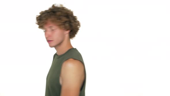 Handsome Curly Cheerful Guy with Green Eyes Walking in Front of Camera Suddenly Stop Showing Thumbs