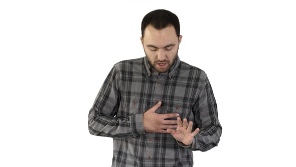 Attractive young man tired after running on white background.