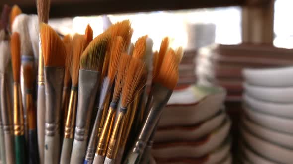 Painting Brushes In Ceramic Workshop