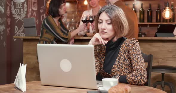 Woman Reading Very Careful and Focused an Important Message at Her Laptop