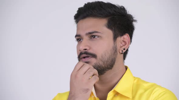 Young Happy Bearded Indian Businessman Thinking While Looking Up